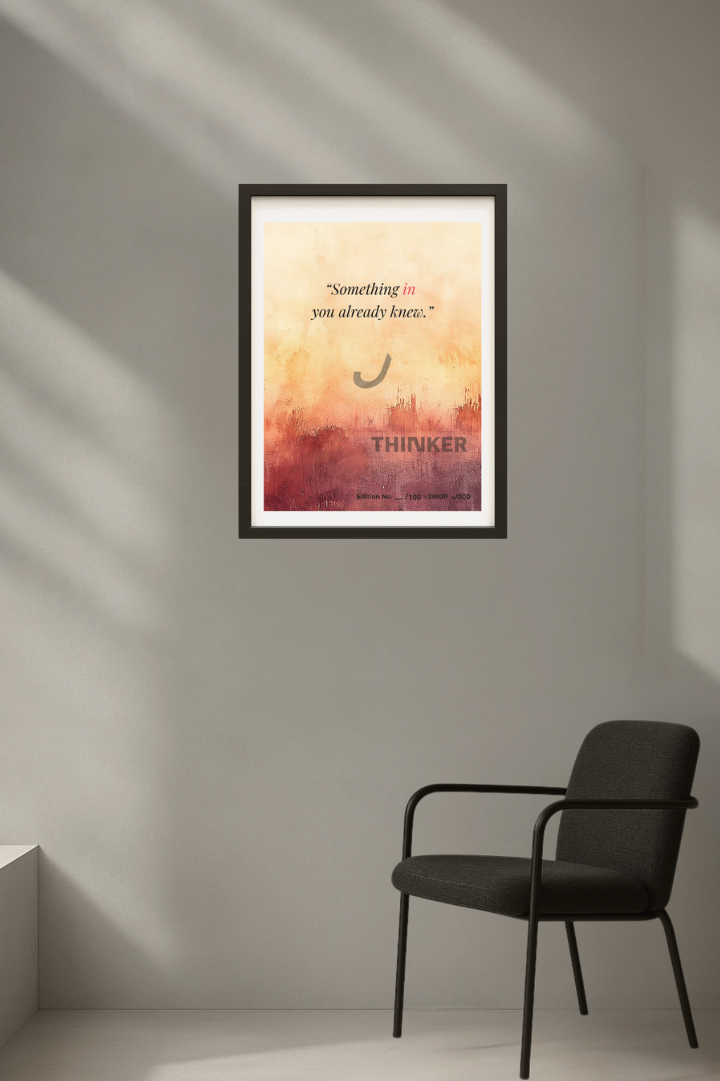 Minimalist gallery-style setting with THINKER Fine Art Giclée Print on a textured gray wall, accented by dramatic light and a sleek black chair.